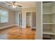 Spacious bedroom boasting hardwood floors, natural light, and closet with shelving at 31 N Broad N St, Porterdale, GA 30014