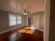 Bright bedroom with hardwood floors, neutral walls, a ceiling fan, and natural light at 31 N Broad N St, Porterdale, GA 30014