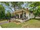 Side view of house showing the landscaped yard, siding, chimney, and black accents on the porch at 31 N Broad N St, Porterdale, GA 30014