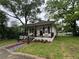 Charming home with inviting front porch, black railings, and a brick and gravel pathway to the front doors at 31 N Broad N St, Porterdale, GA 30014