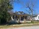 Charming house with a covered front porch, black shutters, and a dormer window at 31 N Broad N St, Porterdale, GA 30014