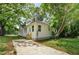 Well-maintained home featuring a manicured lawn, lush trees, and a long driveway at 31 N Broad N St, Porterdale, GA 30014