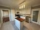 Classic kitchen featuring a center island, stainless steel appliances, and stylish black and white tile flooring at 31 N Broad N St, Porterdale, GA 30014