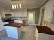 A bright kitchen featuring white cabinets, wood countertops, a center island, and black and white tile flooring at 31 N Broad N St, Porterdale, GA 30014