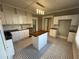 Bright kitchen with custom cabinets, an island, and black and white tile flooring at 31 N Broad N St, Porterdale, GA 30014