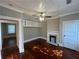 Cozy living room with hardwood floors, a decorative fireplace, and built-in shelving at 31 N Broad N St, Porterdale, GA 30014