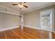 Comfortable living room featuring hardwood floors, built-in shelving, and crown molding at 31 N Broad N St, Porterdale, GA 30014