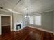 Sunlit living room boasts hardwood floors, fireplace, built-in shelving, and access to additional rooms at 31 N Broad N St, Porterdale, GA 30014