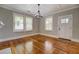 Living room features hardwood floors, modern light fixture, and white trim at 31 N Broad N St, Porterdale, GA 30014