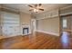 Spacious living room featuring a fireplace, built-in shelving, and beautiful hardwood floors at 31 N Broad N St, Porterdale, GA 30014