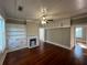 Living room showcasing refinished hardwood floors, built-ins, marble fireplace, and fresh paint at 31 N Broad N St, Porterdale, GA 30014