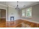 Living room featuring hardwood floors, fireplace, built-in shelves, and natural light from windows at 31 N Broad N St, Porterdale, GA 30014