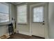Mud room featuring a door and windows with blinds, providing natural light and privacy at 31 N Broad N St, Porterdale, GA 30014