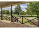 Relaxing porch view showcasing black railings, lush greenery, and a clear view of the neighborhood at 31 N Broad N St, Porterdale, GA 30014