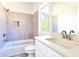 This bright bathroom offers tile surround, a window, and a stylish vanity sink at 727 Copper Trace Way, Woodstock, GA 30189