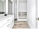 Bathroom featuring gray countertops, white cabinets, and a large soaking tub at 727 Copper Trace Way, Woodstock, GA 30189