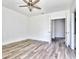 Bright bedroom with wood floors, ceiling fan, and multiple doors leading to other rooms at 727 Copper Trace Way, Woodstock, GA 30189