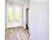 Bright entryway featuring wood floors, white trim, and french doors leading to the outside at 727 Copper Trace Way, Woodstock, GA 30189