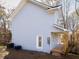 Side view of the 2-story home with light gray siding and a wooden porch at 727 Copper Trace Way, Woodstock, GA 30189