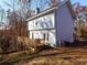 Rear view of the two-story home with wooden deck overlooking a wooded lot at 727 Copper Trace Way, Woodstock, GA 30189