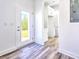 Hallway with white trim, storage, and natural light coming from an open exterior door at 727 Copper Trace Way, Woodstock, GA 30189