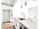 Modern kitchen island featuring white countertops, stainless steel faucet, and ample storage at 727 Copper Trace Way, Woodstock, GA 30189