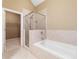 Relaxing bathroom with soaking tub, shower, and access to closet at 255 Kendemere Pointe, Roswell, GA 30075