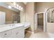 Bathroom boasts double vanity, shower, and linen closet at 255 Kendemere Pointe, Roswell, GA 30075