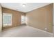 Spacious bedroom with neutral walls and carpet flooring, featuring two windows with plantation shutters at 255 Kendemere Pointe, Roswell, GA 30075