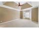 Spacious bedroom with tray ceiling, ceiling fan, and window with plantation shutters at 255 Kendemere Pointe, Roswell, GA 30075