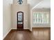 Bright entryway with hardwood floors and an elegant front door at 255 Kendemere Pointe, Roswell, GA 30075