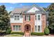 Brick two-story house with white accents and landscaping at 255 Kendemere Pointe, Roswell, GA 30075