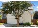 White garage with tree and wooden fence at 255 Kendemere Pointe, Roswell, GA 30075