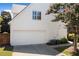 White two-car garage with ample driveway space at 255 Kendemere Pointe, Roswell, GA 30075