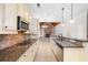 Kitchen with granite countertops, stainless steel appliances, and view of Gathering room fireplace at 255 Kendemere Pointe, Roswell, GA 30075