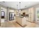 Kitchen features an island, stainless steel appliances, and a view into the living room at 255 Kendemere Pointe, Roswell, GA 30075