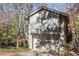 Gray house with attached garage and wooden deck, surrounded by trees at 355 N Peak Dr, Alpharetta, GA 30022