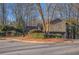 Well maintained exterior view of a house with manicured landscaping and mature trees in a circular driveway at 355 N Peak Dr, Alpharetta, GA 30022