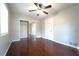 Bedroom featuring dark hardwood floors, ceiling fan and a mirrored closet at 2020 Kenwood Se Pl, Smyrna, GA 30082