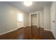 This bedroom features hardwood floors, a closet, and a white exterior door at 2020 Kenwood Se Pl, Smyrna, GA 30082