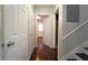 Hallway view with hardwood floors and a number of white doors at 2020 Kenwood Se Pl, Smyrna, GA 30082