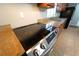 Close up of range and granite countertops in kitchen with wood cabinets at 2020 Kenwood Se Pl, Smyrna, GA 30082