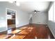 Open living area with hardwood floors connects to kitchen, featuring natural light, ceiling fan, and neutral color palette at 2020 Kenwood Se Pl, Smyrna, GA 30082