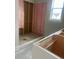 Bathroom features a shower stall with pink insulation, along with sink cabinet and light from the window at 108 Cottage Gate Ln, Roswell, GA 30076