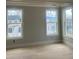 Bedroom features bright natural lighting from windows and neutral gray walls at 108 Cottage Gate Ln, Roswell, GA 30076