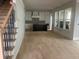 Open concept living room and kitchen with hardwood floors, black kitchen island, and white cabinets at 108 Cottage Gate Ln, Roswell, GA 30076