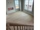 View of the living room from the staircase, with a fire place and large windows for natural lighting at 108 Cottage Gate Ln, Roswell, GA 30076