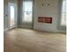 Living room features a cozy fireplace with white shiplap surround and large windows for natural light at 108 Cottage Gate Ln, Roswell, GA 30076