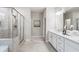 Bright bathroom with double sinks, modern fixtures, walk-in shower and bright light at 5133 Greenard Watson Lane, Buford, GA 30518