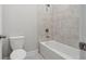 Bathroom with a tub-shower combination, grey tiles and updated fixtures at 5133 Greenard Watson Lane, Buford, GA 30518